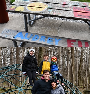 A picnic table outside under the Sablosky Pavilion with the name Audrey painted in blue in the bench and pizza and French fries painted on top; the Erdel family posing by a green geodesic dome play structure