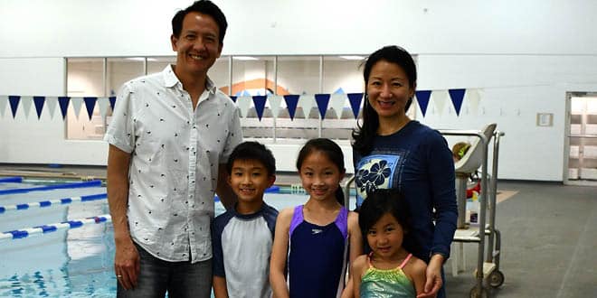 An Asian family (a man, a woman, two young girls and a young boy) on the deck of the Regenstrief Natatorium