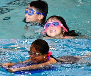 An Asian boy and two Asian girls in swimming pools