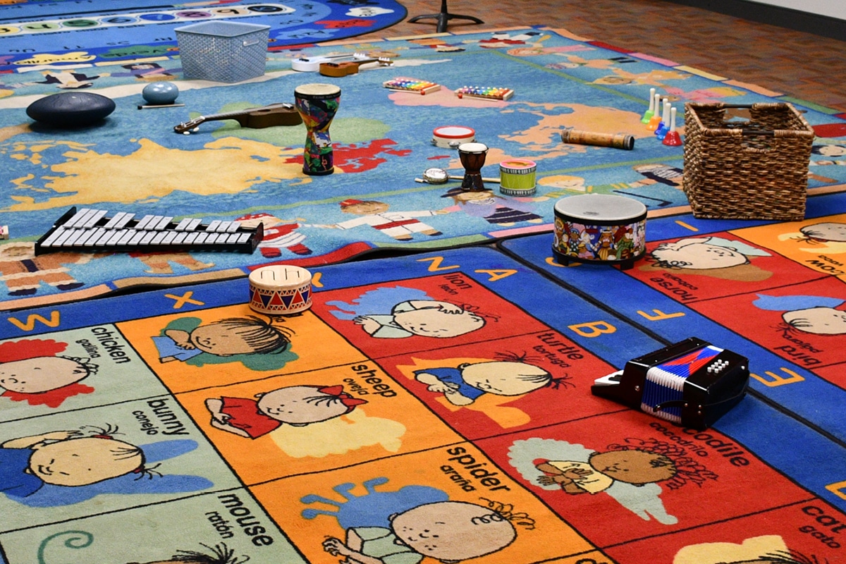 Musical instruments scattered over a colorful rug for a Music Playhouse class